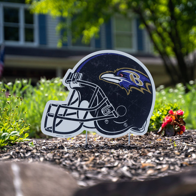 The Baltimore Ravens logo is seen on helmets on the field before